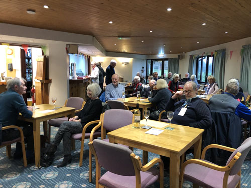 People sitting at tables in the Social Club