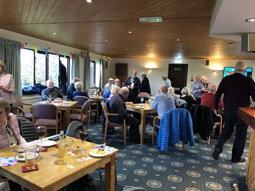 View from the back of the Social Club showing people queueing and some at tables