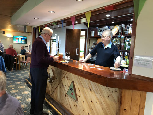 Pat being served at the bar by Len