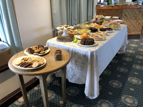 Tables laden with cakes, biscuits and crisps