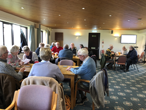 Looking towards the TV end of the Clubhouse. People at tables working on the Picture Round