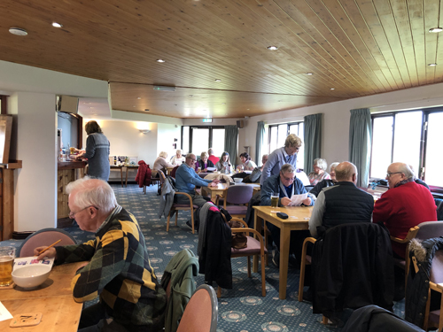 Looking from the TV end of the Clubhouse - tables with people working on the Picture Round.