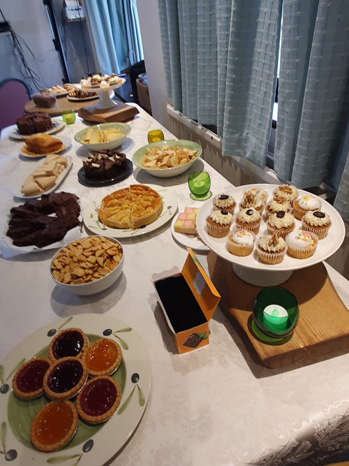 Close up on food on table. Jam tarts, cupcakes, brownies, shortbread, crisps etc