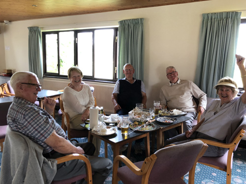 Brian, Joan, Len, Pat and Brenda sitting at a table in the Clubhouse