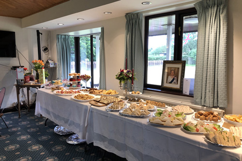 Tables with food and candelabra. Picture of the Queen