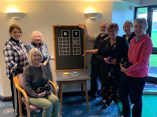 Kath, Thora, Anne, Dave, Wendy, Joan and Chris in front of the new Scoreboard