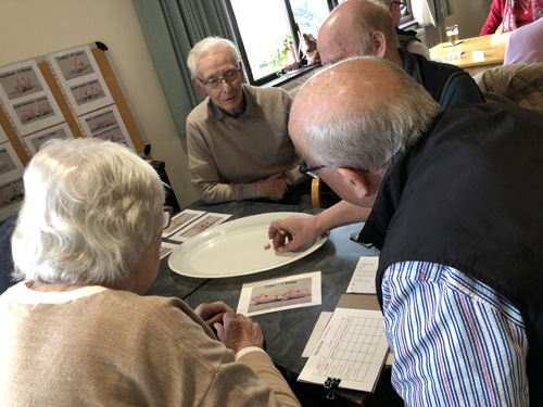 Alan, Anita, Graham and Mike playing 'Pass The Pigs'. Alan examing the most recent throw to determine the score