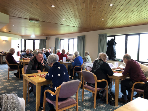 A view of the Clubhouse from the TV end. People sitting at tables playing games