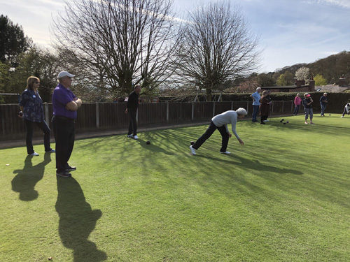 Sheila bowls watched by Alan and Laura. Other games going on in the background