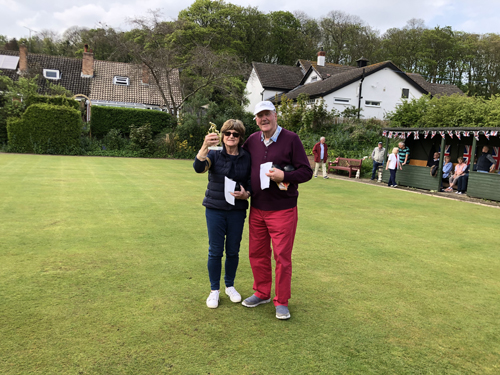 Winners Jill & Pat on the green. Jill is holding the trophy.