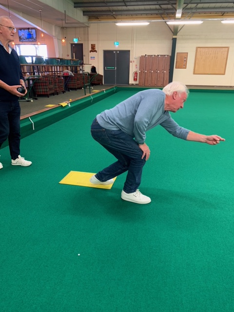 Brian bowling with Len watching