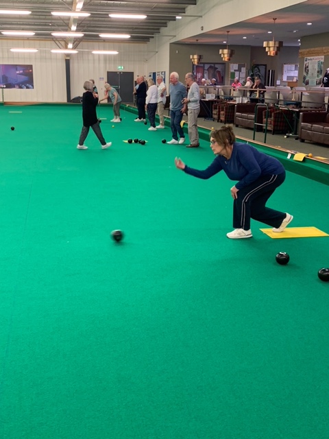 View of lanes and games in progress. Thora bowling in the foreground