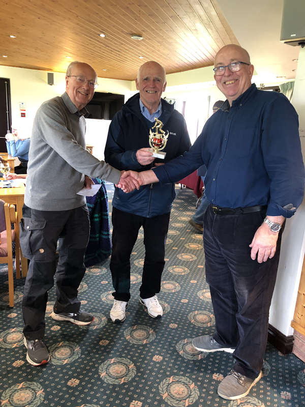 Geoff presents the trophy to Mike and Alan. In the Clubhouse.