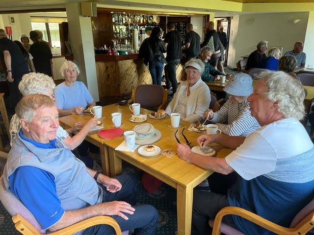 Claremount members sitting at a table in the Clubhouse.