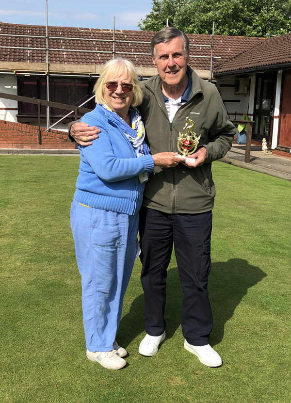 David accepts the trophy from Margie