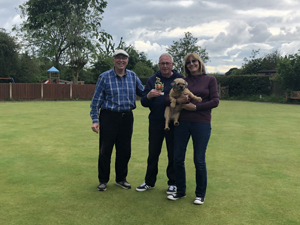 Mike and Laura (and Sally the dog, held in Laura's arms) accept the trophy from Alan.