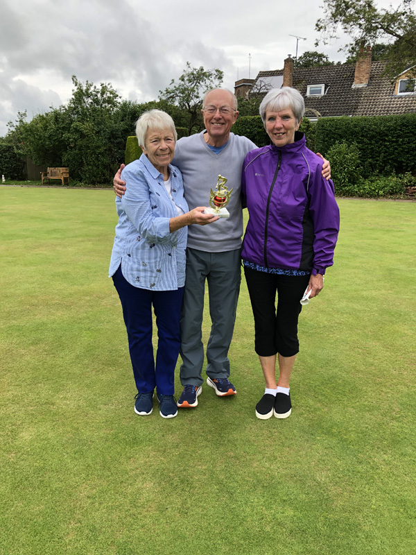 Sandra and Margaret pose with the trophy. Geoff stands between them.