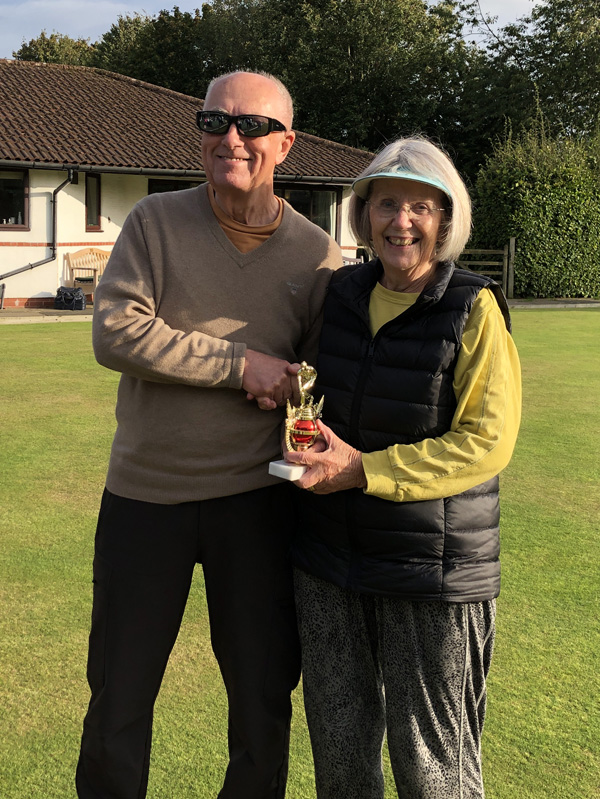 Geoff presents the trophy to Kath.