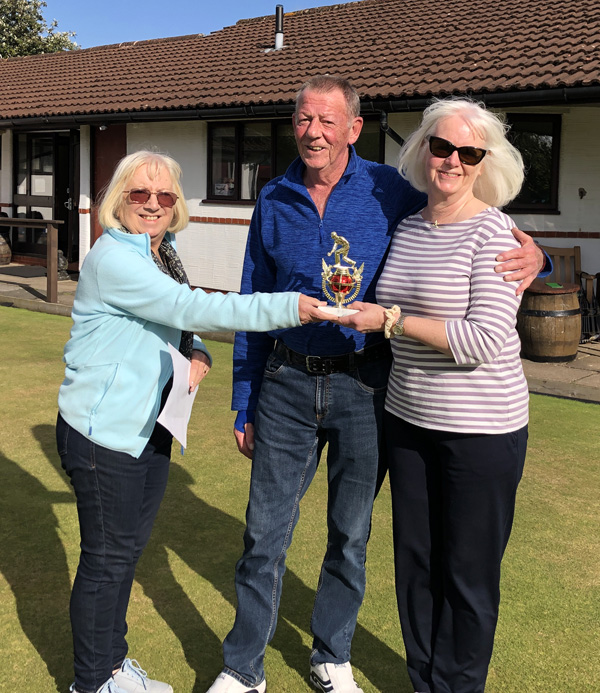 Margie presents the trophy to Roy and Karen.