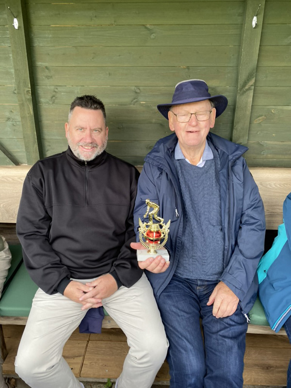 Sitting in the Bowls Shelter, Mark and Len pose with the trophy