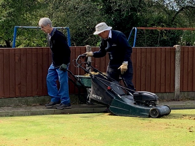 Ian picks up remaining moss using the rotary mower, helped by John