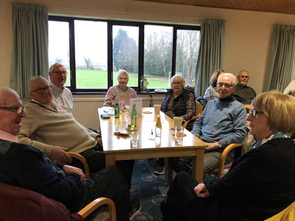 Pat, Dave, Maggie, Anita and Grahame seated at a table.